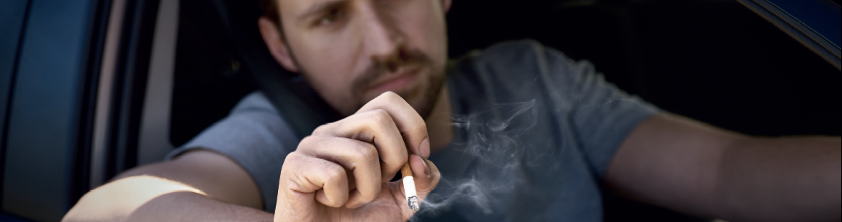 Man throwing cigarette butt from car