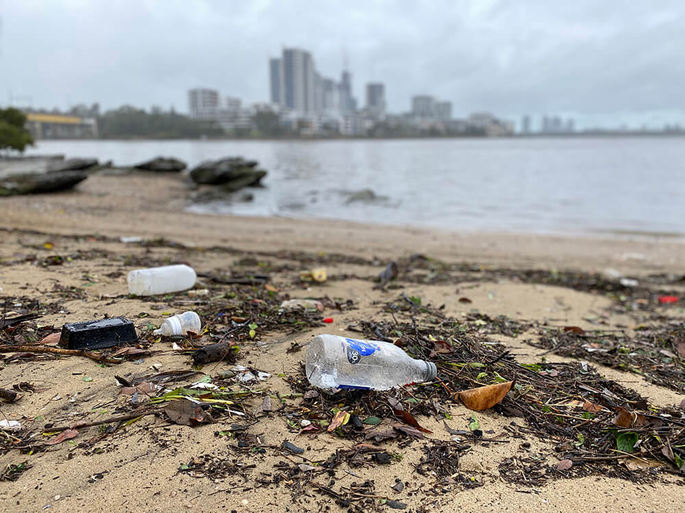 Littered rubbish on the banks of a river