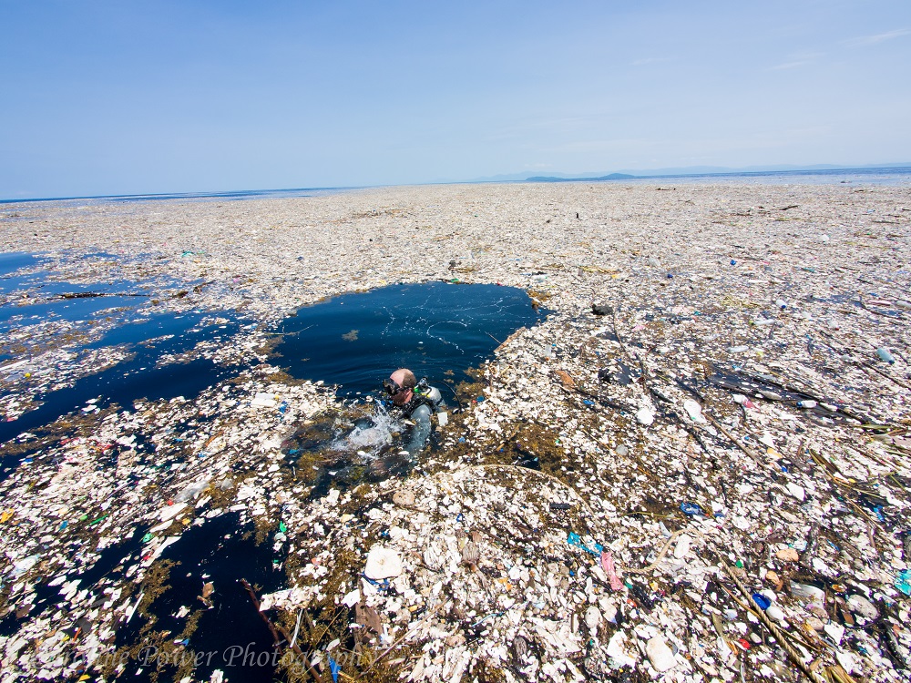 Diver surrounded by rubbish 